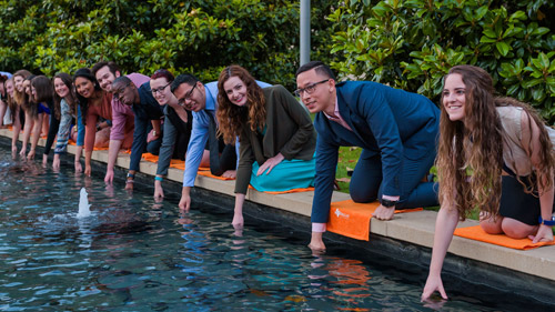 Alumni dunking their rings in the reflecting pools. 